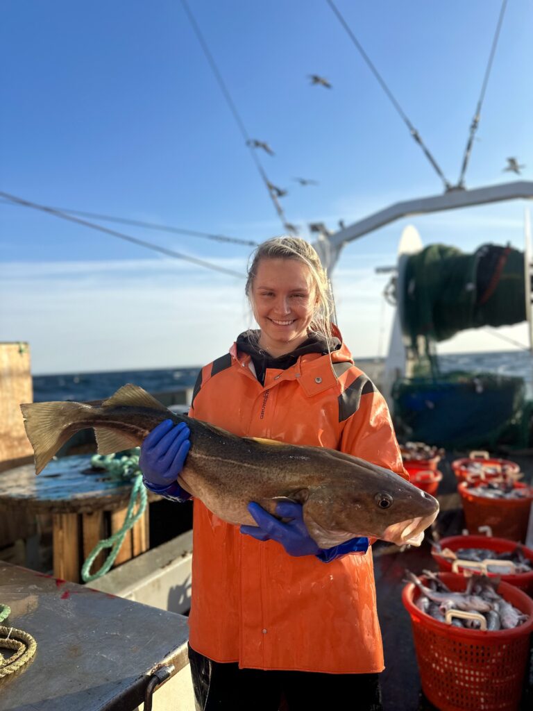 student holding a fish